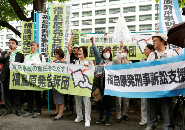 Complainants stage a rally in front of the Tokyo District Court, where former top officials of Tokyo Electric Power Co went on the first criminal trial over the 2011 Fukushima Daiichi nuclear plant disaster in Tokyo, Japan on Friday. (Kyodo photo via Reuters)