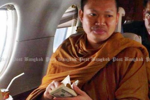 One of the early revelations about the then-monk Luang Pu Nem Kham was his use of private helicopters and jet planes - while flaunting stacks of US currency. (Bangkok Post file photo) One of the early revelations about the then-monk Luang Pu Nem Kham was his use of private helicopters and jet planes - while flaunting stacks of US currency. (Bangkok Post file photo)