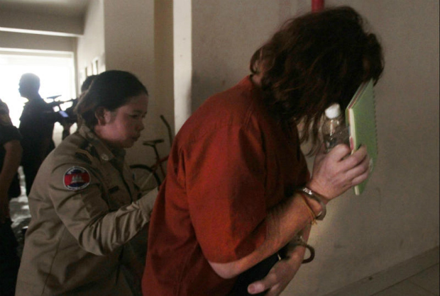 Australian Tammy Davis-Charles, right, charged with providing commercial surrogacy services, hides her face as she enters the Phnom Penh Municipal Court in Phnom Penh, Cambodia on Monday. (AP Photo) Australian Tammy Davis-Charles, right, charged with providing commercial surrogacy services, hides her face as she enters the Phnom Penh Municipal Court in Phnom Penh, Cambodia on Monday. (AP Photo)