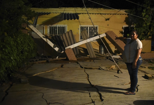 A woman points at her damaged house in Coatzacoalcos, in Veracruz state of southern Mexico, after an 8.2 magnitude earthquake on Friday. (EPA Photo)