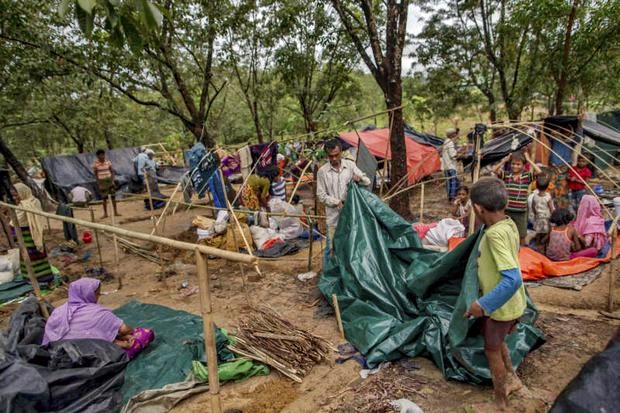 A group of Rohingya families tear down their makeshift shelters to prepare to move to a registered refugee camp in Bangladesh on Sunday. (AP photo) A group of Rohingya families tear down their makeshift shelters to prepare to move to a registered refugee camp in Bangladesh on Sunday. (AP photo)