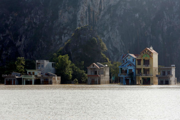 Submerged houses are seen at a flooded village after a heavy rainfall caused by a tropical depression in Ninh Binh province, Vietnam, on Saturday. (Reuters photo) Submerged houses are seen at a flooded village after a heavy rainfall caused by a tropical depression in Ninh Binh province, Vietnam, on Saturday. (Reuters photo)