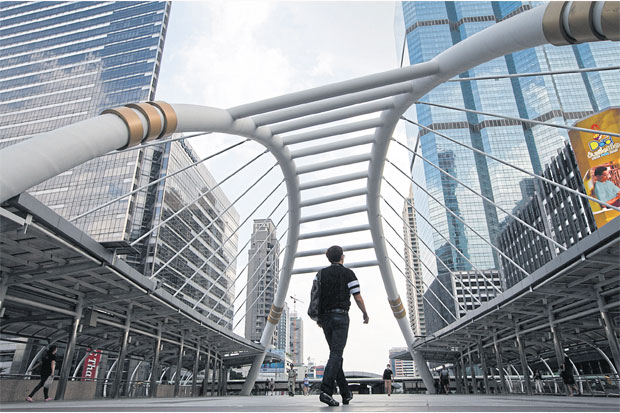 Commuters walk on the Chong Nonsi Skywalk in Bangkok. SEKSAN ROJJANAMETAKUN