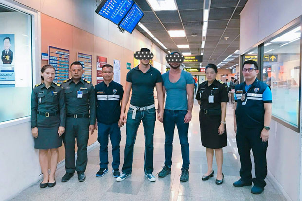 Immigration police arrested two Americans at Don Mueang airport and said they confessed to posing for photos at the Temple of Dawn while showing their naked buttocks. (Immigration police photo)