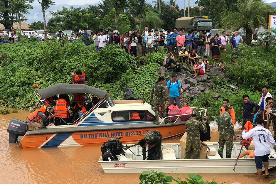 Rescuers work at a flooded site after the dam collapse on Tuesday. — Mime Phoumsavanh/Reuters