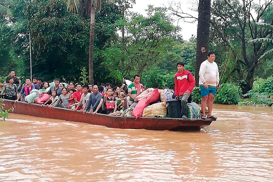 People on a boat are evacuated in the floodwaters from the collapsed Xe Pien-Xe Nammoy dam in Sanamxay district, Attapeu province, on Tuesday. — Attapeu TV/ AP