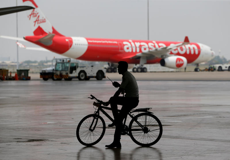 A security guard rides a bicycle past an AirAsia plane at the Garuda Maintenance Facility AeroAsia in Tangerang, Indonesia, on Sept 20, 2017. (Reuters photo) A security guard rides a bicycle past an AirAsia plane at the Garuda Maintenance Facility AeroAsia in Tangerang, Indonesia, on Sept 20, 2017. (Reuters photo)
