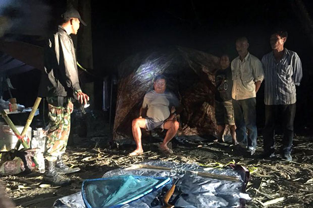 Park ranger arrest construction tycoon Premchai Karnasuta (seated) and other three others suspected of poaching wildlife at their camping site in a prohibited area of the World Heritage Thungyai Naresuan Wildlife Sanctuary in Kanchanaburi on Sunday. (EPA-EFE/Department of National Parks, Wildlife and Plant Conservation) Park ranger arrest construction tycoon Premchai Karnasuta (seated) and other three others suspected of poaching wildlife at their camping site in a prohibited area of the World Heritage Thungyai Naresuan Wildlife Sanctuary in Kanchanaburi on Sunday. (EPA-EFE/Department of National Parks, Wildlife and Plant Conservation)