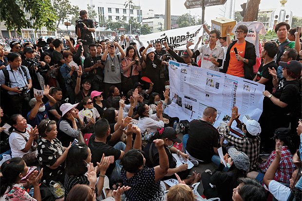 GIVE THE POWER BACK: Pro-election activists join a protest led by Rangsiman Rome (wearing orange T-shirt) demanding the regime hold elections this year. GIVE THE POWER BACK: Pro-election activists join a protest led by Rangsiman Rome (wearing orange T-shirt) demanding the regime hold elections this year.