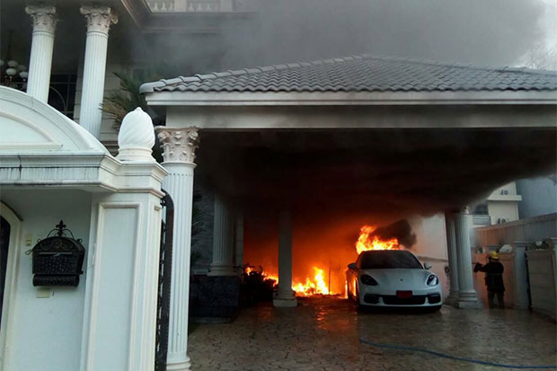 The Porsche Panamera catches fire as firefighters reach the house on Friday. (Photos from @ThaiRescueNews Facebook)