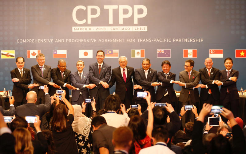 Representatives of member countries of the Trans-Pacific Partnership trade pact pose for an official picture after the signing ceremony in Santiago on March 8, 2018. (Reuters photo)