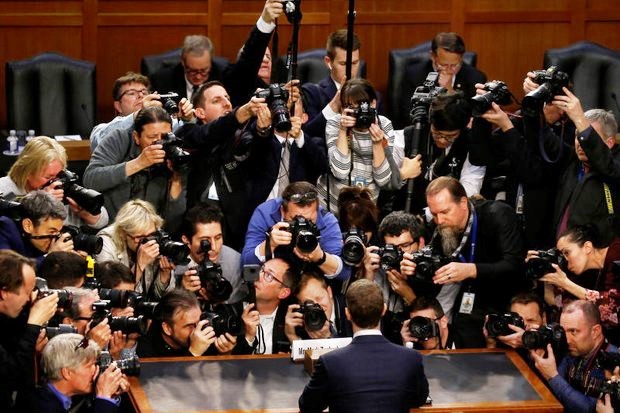 Photographers pushed towards the witness table to get a photo of Facebook chief Mark Zuckerberg before he began testimony at the US Congress on Tuesday. (Reuters photo)