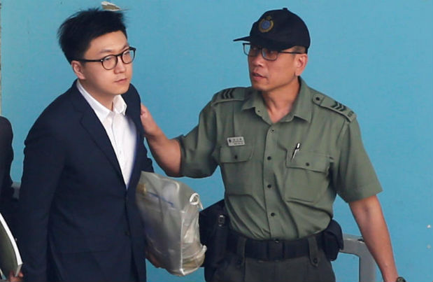 Pro-independence activist Edward Leung is held by a correctional services department officer inside a detention centre before leaving for the High Court for a sentencing hearing in Hong Kong, China June 11, 2018. (Reuters photo) Pro-independence activist Edward Leung is held by a correctional services department officer inside a detention centre before leaving for the High Court for a sentencing hearing in Hong Kong, China June 11, 2018. (Reuters photo)