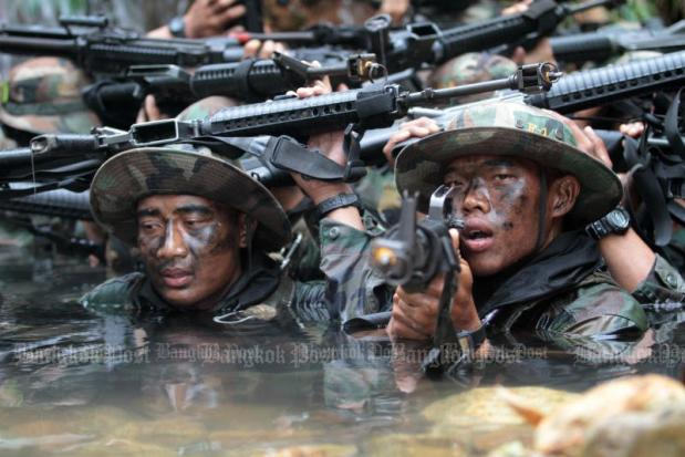 Seals of the navy's Underwater Demolition Team struggle through a muddy training course during the annual 120-hour Hell Week at the conclusion of their one-year brutal basic training. (File photo by Jetjaras na Ranong)