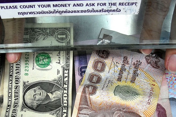 Kasikornbank now forecasts the baht will drop to 34 per US dollar by the end of August - and then reverse to 33/dollar by New Year's Eve. (AFP file photo) Kasikornbank now forecasts the baht will drop to 34 per US dollar by the end of August - and then reverse to 33/dollar by New Year's Eve. (AFP file photo)