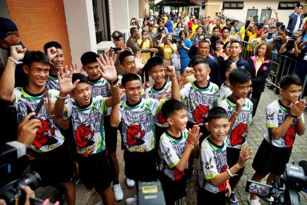 Most of the rescued boys and coach, seen here at a government-mandated TV press conference, have been to religious ceremonies but now will be ordained. (Reuters photo)