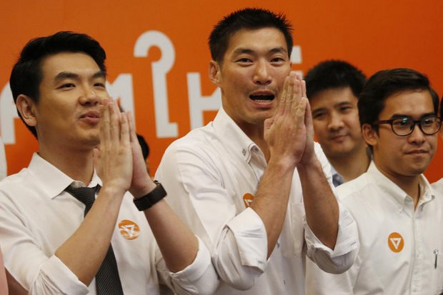 Future Forward founder Thanathorn Juangroongruangkit (centre) and two others are charged with a 'false' Facebook broadcast, apparently over statements that the regime is poaching politicians. (File photo)