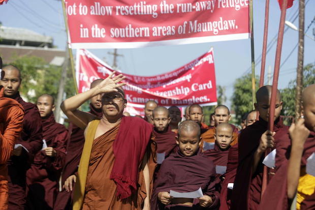 Rakhine Buddhist monks hold posters and placards during the protest in Sittwe, Rakhine State, Myanmar, on Sunday. (AFP photo).