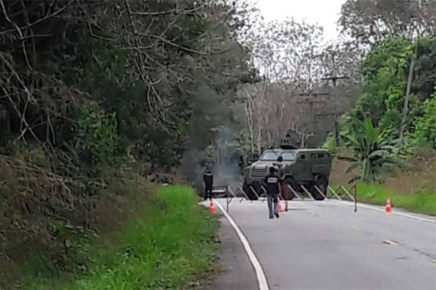 Soldiers cordon off the shooting scene on a road in Sri Sakhon district, Narathiwat, after gunmen opened fire from ambush at three rangers on board a pickup truck on Saturday afternoon. (Photo by Waedao Harai)