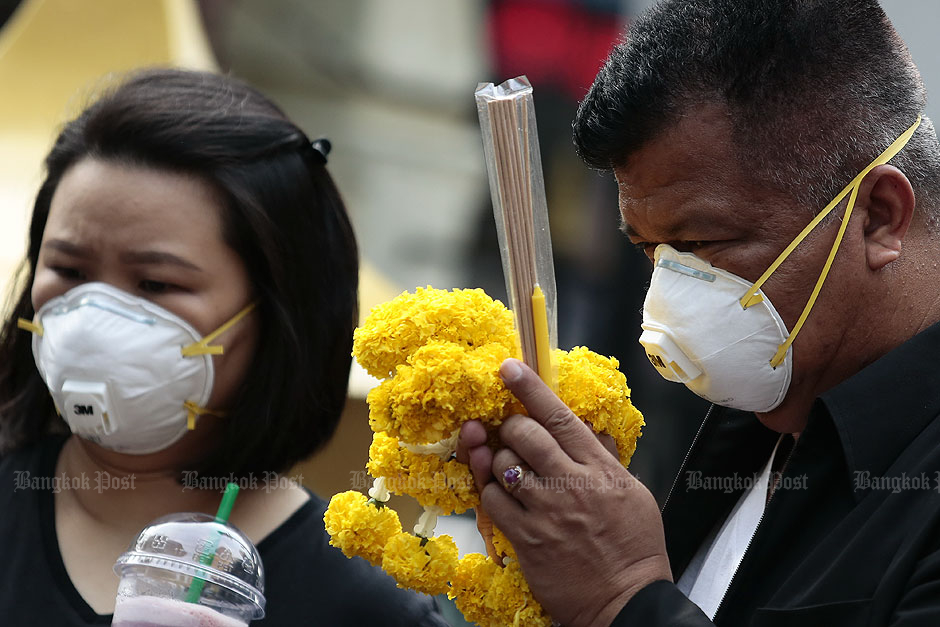 Tourists pray at the Erawan Shrine in Bangkok. — Patipat Janthong