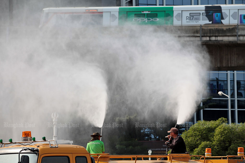 A powerful water cannon sprays a mist to help reduce the hazardous ultra-fine dust known technically as PM2.5 that has blanketed many parts of Bangkok. — Chanat Katanyu