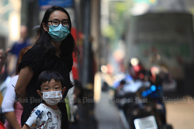 People wear facemasks in Bangkok on Monday as PM2.5 levels increased, posing a bigger threat to people’s health. (File photo)