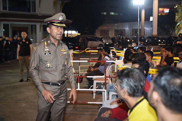 Pol Lt Gen Surachate Hakparn, commissioner of the Immigration Bureau, talks to some of the foreigners caught during Friday morning's "X-Ray Outlaw Foreigners" raids at 239 locations in Bangkok and other provinces. (Supplied photo)