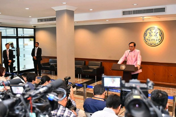 Prime Minister Prayut Chan-o-cha speaks to the press after Tuesday's cabinet meeting. He must walk a fine line between national leader and political candidate. (Post Today photo)