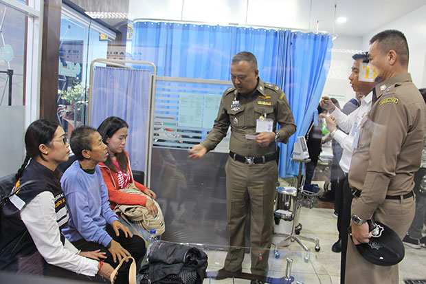 Kaewmanee Arjor, 59, seated centre, found in China eight months after she went missing, is questioned by a senior immigration officer as she is reunited with her daughter after arriving at Chiang Rai airport on Friday. (Photo by Chinpat Chaimon)