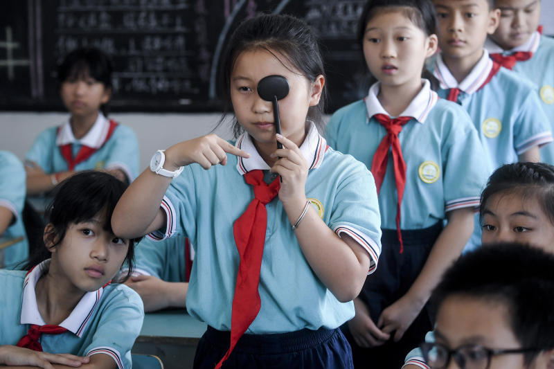 Students line-up to get eyesight test at a primary school in Donglin Township of Huzhou City, east China's Zhejiang province. (Xinhua via AP photo)