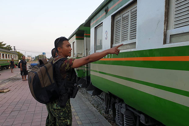 Soldiers inspect a Sungai Kolok-Yala passenger train after an unknown number of men fire shots at the train in Rueso district, Narathiwat, on Friday evening. No passengers were hurt, but the train was slightly damaged. (Photo by Waedao Harai)