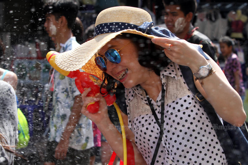 A tourist enjoys getting wet during the Songkran festival on Khaosan Road in April last year. (Photo by Apichart Jinakul)