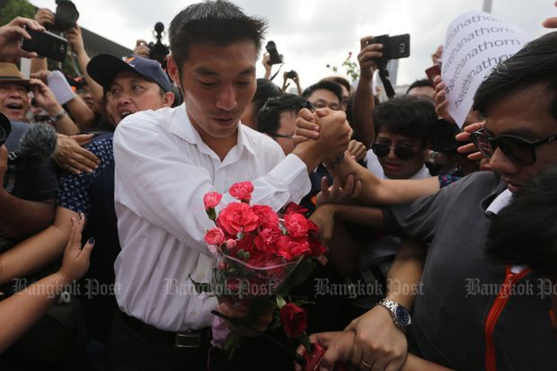 Future Forward Party leader is greeted by supporters before entering the Pathumwan police station to hear charges against him on Saturday morning. (Photos by Wichan Charoenkiatpakul)