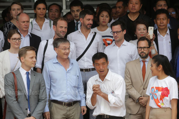 Foreign observers at Pathumwan police station on Saturday when Future Forward Party leader Thanathorn Juangroongruangkit (front centre) reported to answer charges involving a pro-democracy rally in 2015. (Photo by Wichan Charoenkiatpakul)