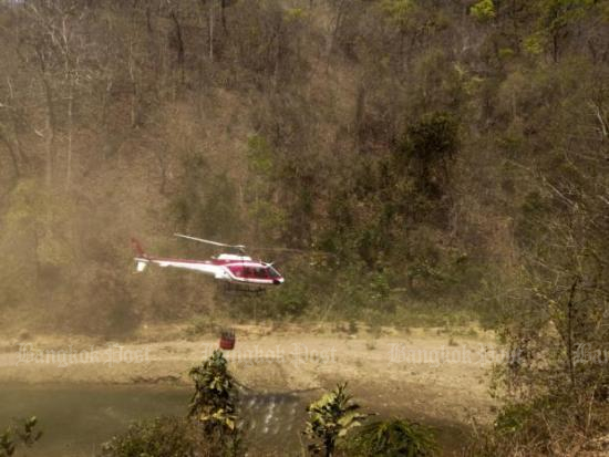 A helicopter airlifts water to fight bush fires in Salawin National Park in Mae Hong Son. Helicopters have made over 100 trips to drop water. Photo courtesy of the Department of National Parks, Wildlife And Plant Conservation.