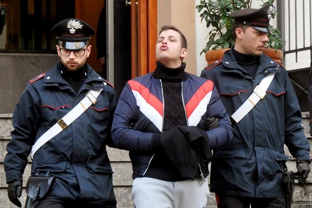 An arrogant Leandro Greco, centre,  grandson of famed mobster Michele Greco, blows a kiss as he is escorted to the Carabinieri's headquarters on Jan 22, 2019, in Palermo, after his arrest. Anti-mafia police said  they had dealt a fresh blow to Italy's Cosa Nostra, arresting seven suspected rising-star mobsters after two of the organised crime group turned state witnesses.The raids followed a major swoop against the resurgent Sicilian mafia in December when a jeweller was captured just before he was due to be officially anointed "boss of bosses" of the reconvened Mafia Commission or Cupola. (Photo: AFP)