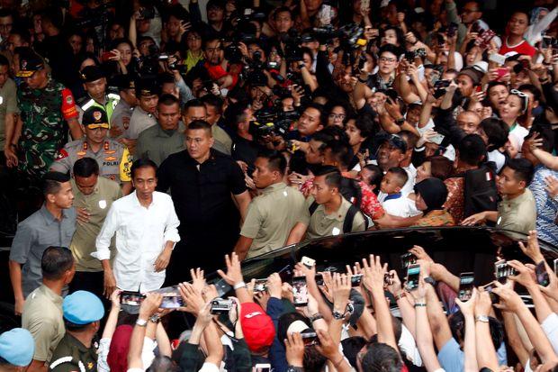 Indonesia's President Joko Widodo reacts after a quick count result during the Indonesian elections in Jakarta on Wednesday