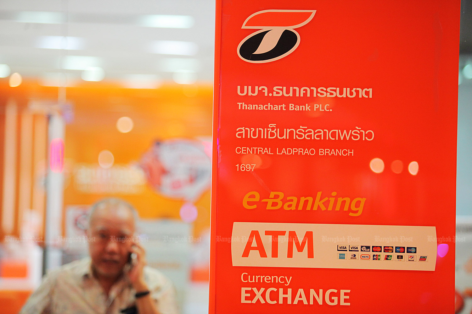 A man walks pasta Thanachart Bank branch. Accenture’s research suggests that 94% of bank customers are willing to share personal data in exchange for rapid loan approval. (Photo by Wichan Charoenkiatpakul)