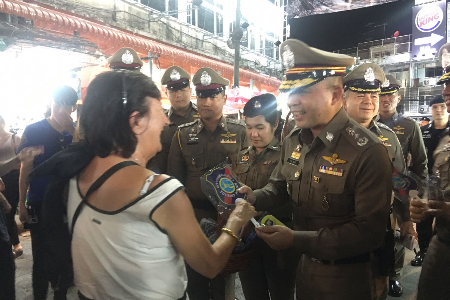 Assistant national police chief Pol Lt Gen Piya Uthayo (right) talks to a foreigner on Khao San Road in Bangkok on Wednesday night as police were enforcing laws on foreigners' visits and stays at many locations nationwide.(Photo supplied)