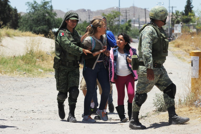 Mexican National Guard soldiers detain Central American migrants trying to cross the Rio Bravo - also known as the Rio Grande - into the United States at Ciudad Juarez. Mexican National Guard soldiers detain Central American migrants trying to cross the Rio Bravo - also known as the Rio Grande - into the United States at Ciudad Juarez.