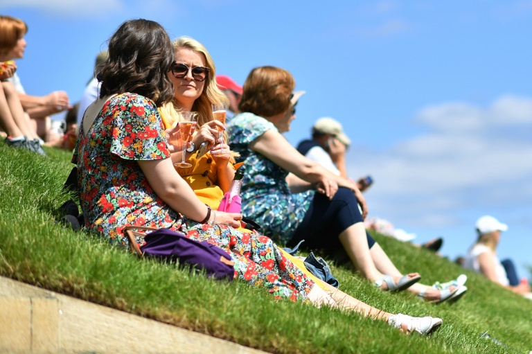 Spectators drink on the grass of the Aorangi Terrace at Wimbledon Spectators drink on the grass of the Aorangi Terrace at Wimbledon