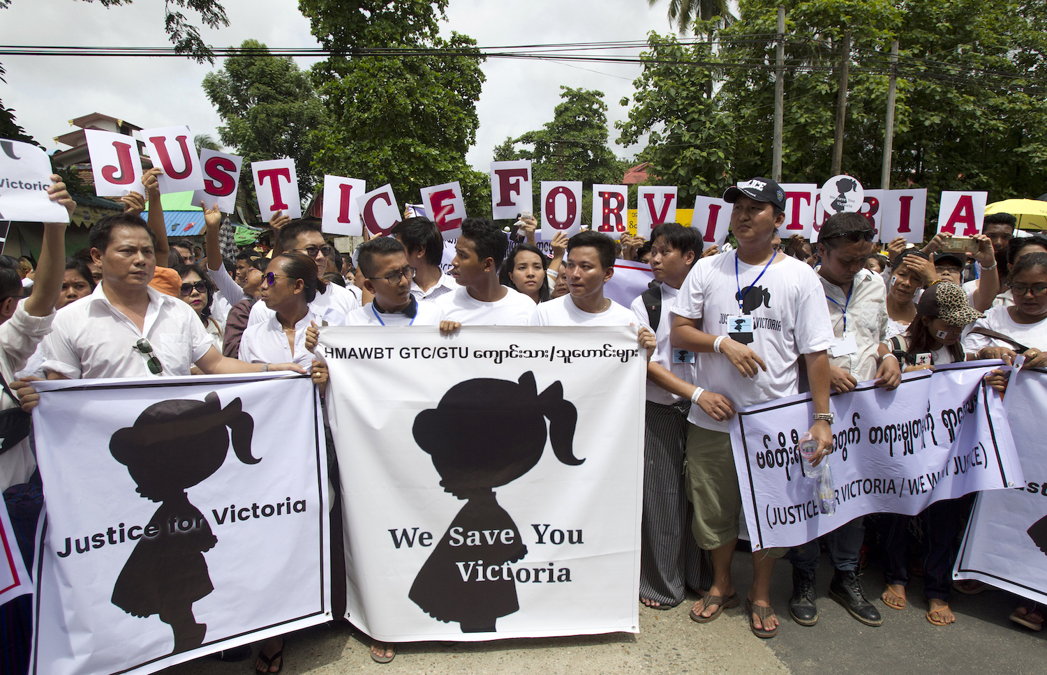 Marchers stage a protest in Yangon on Saturday to demand police account for their handling of a case in which a 3-year-old girl was raped in a nursery school in May. (AP Photo)