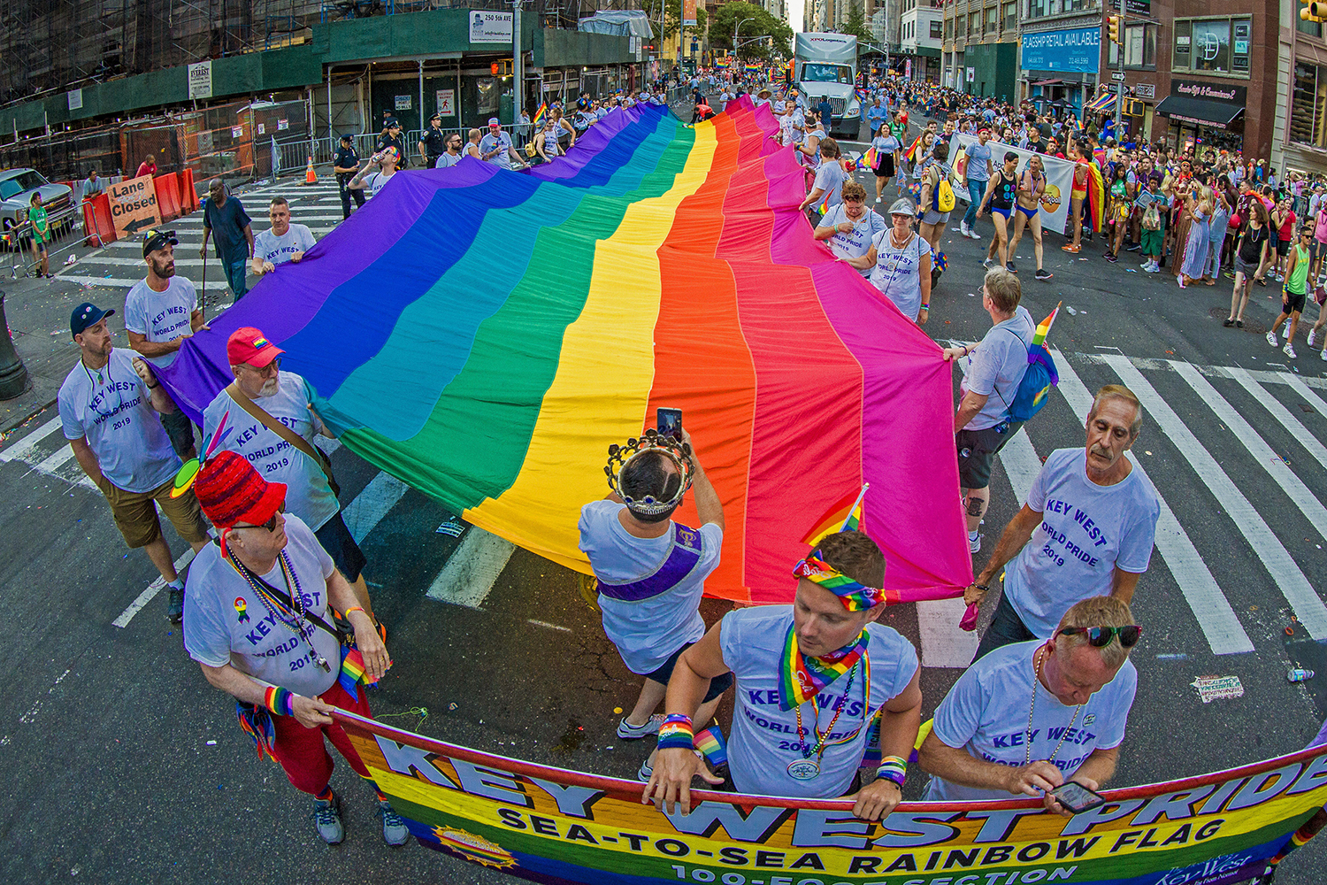 Participants carry a 100-foot-long rainbow flag during the recent LGBTQ Pride march in New York. (Florida Keys News Bureau via AP photo)