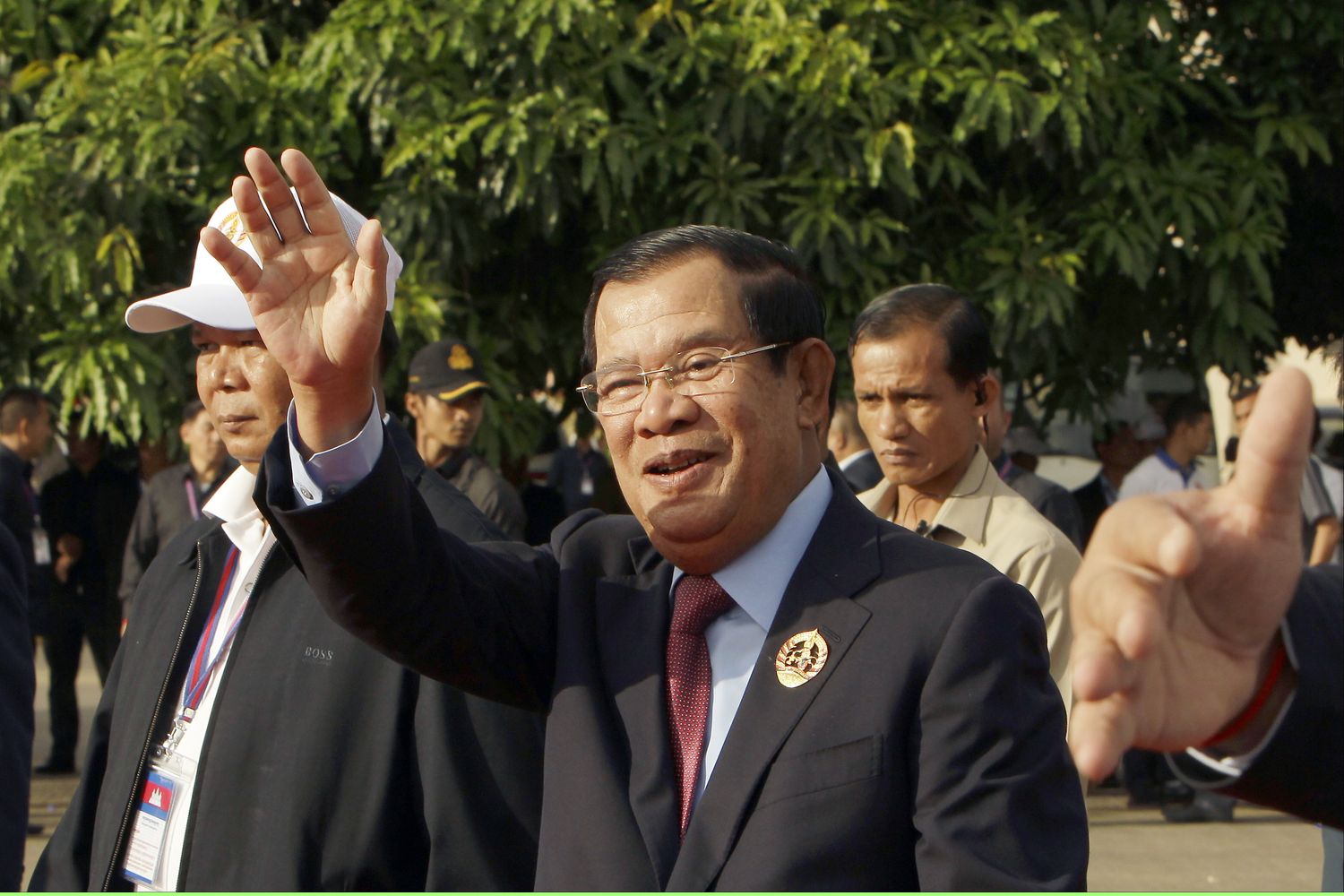 Cambodian Prime Minister Hun Sen waves to his party supporters during the 68th anniversary for the founding of his Cambodian People's Party in Phnom Penh on June 28. Hun Sen denied reports he was allowing China to set up a military outpost in the country. (AP photo)