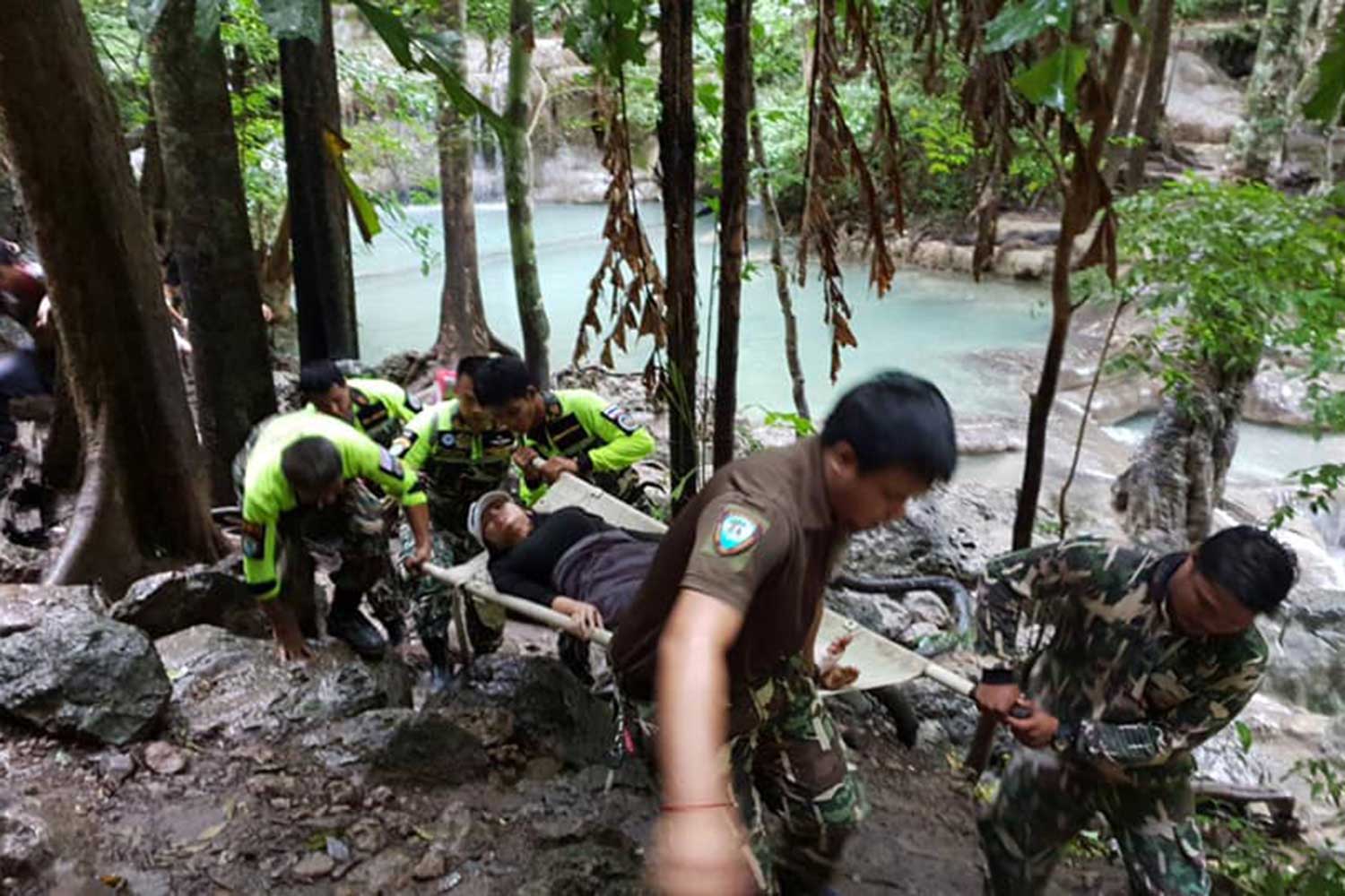 Officials carry an injured visitor from the Erawan waterfall in Si Sawat district of Kanchanaburi.  (Photo taken from the Erawan National Park Facebook page)