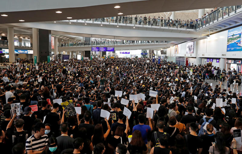 Protesters attend a mass demonstration at Hong Kong International Airport, in Hong Kong on Monday. (Reuters photo)