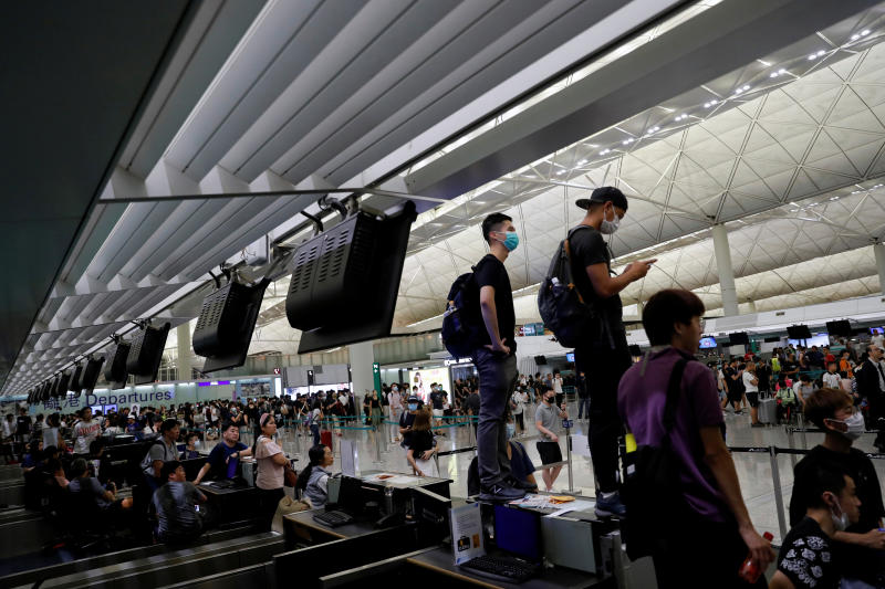 Anti-Extradition bill protesters are seen on the check-in counter during a mass demonstration at the Hong Kong international airport on Tuesday. (Reuters photo) Anti-Extradition bill protesters are seen on the check-in counter during a mass demonstration at the Hong Kong international airport on Tuesday. (Reuters photo)