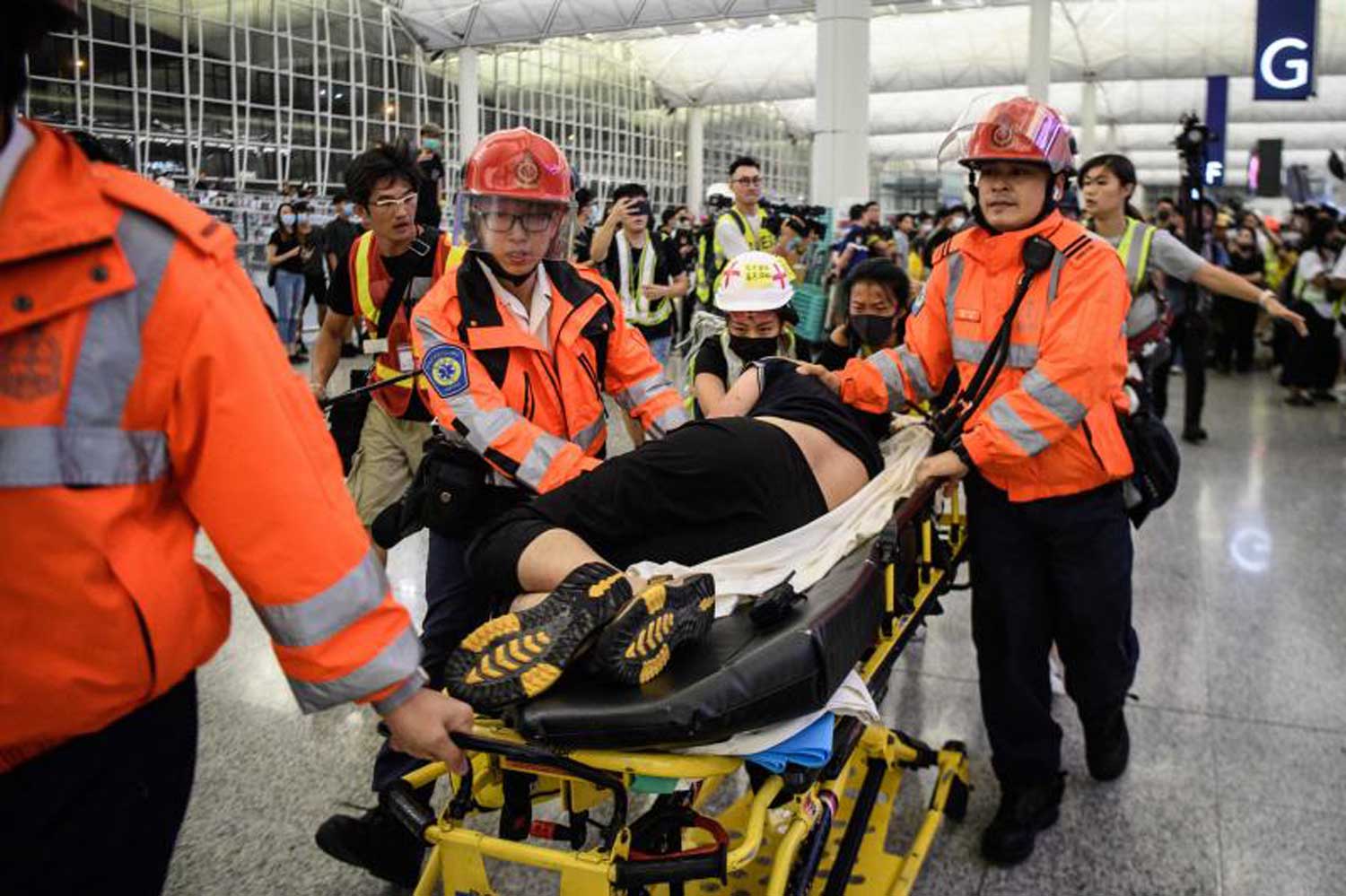 An injured man who was suspected by protestors of being a Chinese spy is taken away by paramedics at Hong Kong’s international airport early on Wednesday. (AFP photo) An injured man who was suspected by protestors of being a Chinese spy is taken away by paramedics at Hong Kong’s international airport early on Wednesday. (AFP photo)