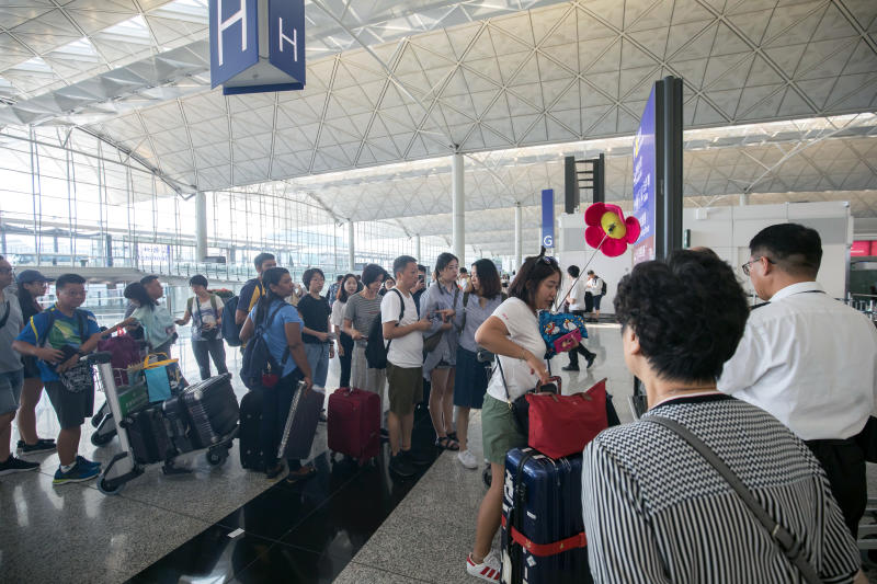 Travellers queue in the departure hall at Hong Kong international airport on Wednesday. (Bloomberg photo) Travellers queue in the departure hall at Hong Kong international airport on Wednesday. (Bloomberg photo)
