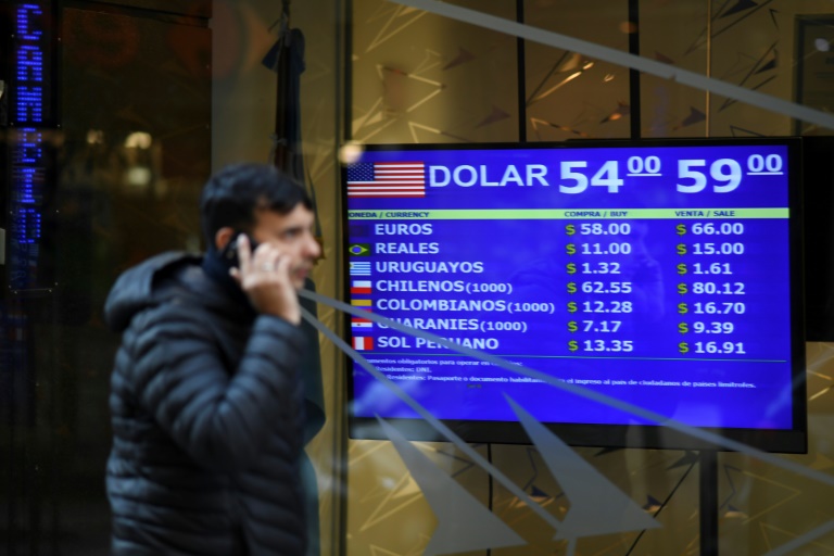 Currency exchange values are displayed on the buy-sell board in Buenos Aires, on August 13, 2019 Currency exchange values are displayed on the buy-sell board in Buenos Aires, on August 13, 2019